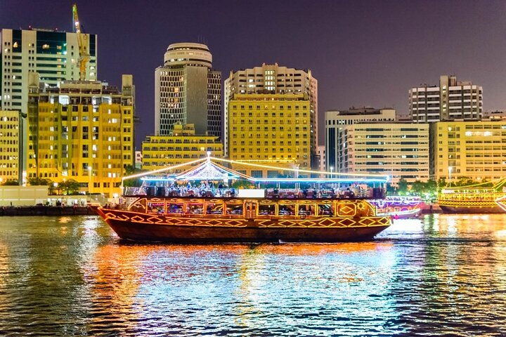 Experience the charm of Dubai Creek aboard a traditional dhow where historic tales blend with sparkling city lights and a delightful buffet awaits under the stars.